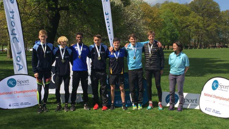 <p>SE men's cross country team with their gold medals</p>