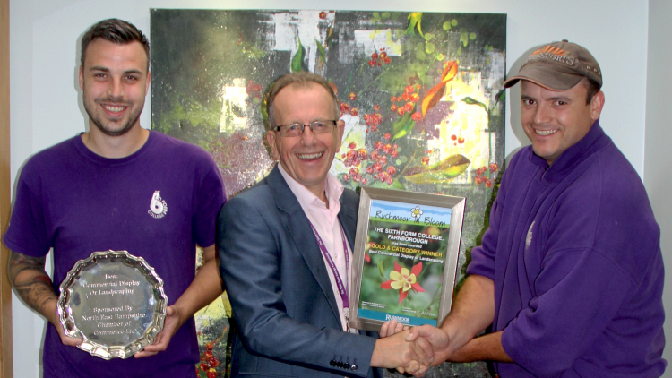 <p>Groundsmen Dean and Trevor with Principal Simon Jarvis and their award</p>