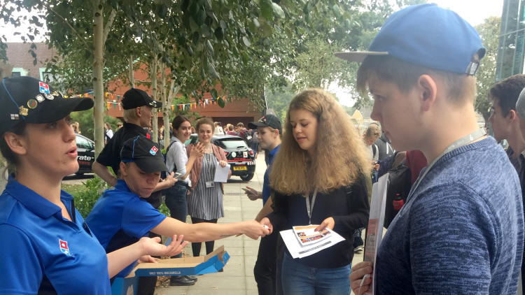 <p>Students enjoying free Domino's Pizza</p>