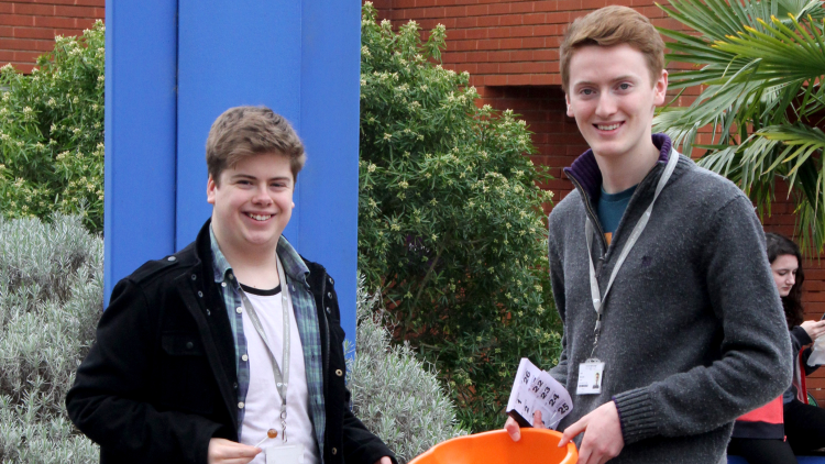 <p>&nbsp;Olly Allen and Jack Bennett collecting money</p>