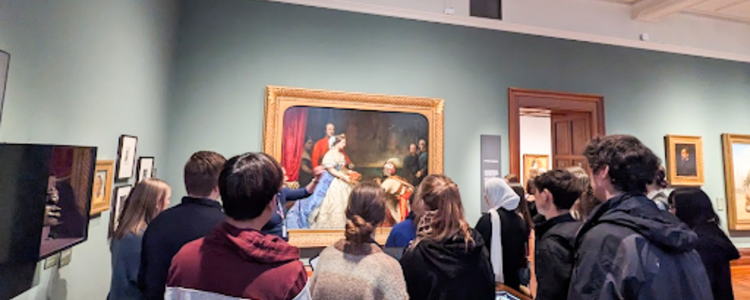 Students viewing the artwork on display 